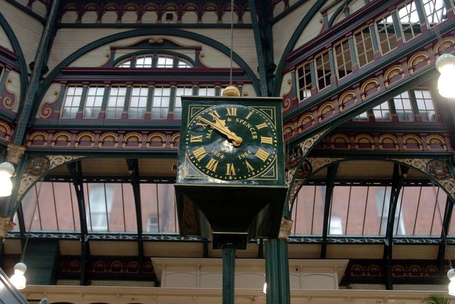 The Marks and Spencer clock inside Kirkgate Market showing the magnificent architecture above the stalls.