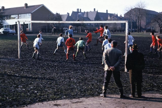 Football being played on what used to be lawn and flower beds in Lewisham Park. The original gates into the park can be seen by the left hand goal posts.