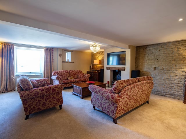 A feature wall with open stonework adds to the character of the lounge.