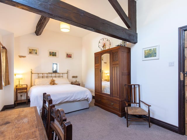 Open ceiling vaults in this double bedroom within the property.