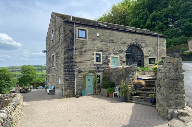 The attractive property, for sale at £550,000, has a high vantage point above the Calder Valley.