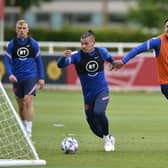 FULLY FIT: Leeds United star Kalvin Phillips, centre, gets away from England team mate Harry Maguire, right, during Three Lions training at St George's Park this week. Photo by Nathan Stirk/Getty Images.