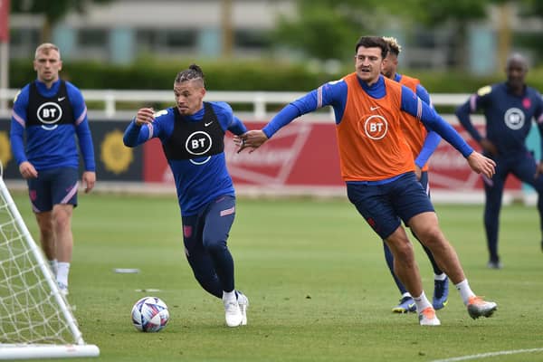 FULLY FIT: Leeds United star Kalvin Phillips, centre, gets away from England team mate Harry Maguire, right, during Three Lions training at St George's Park this week. Photo by Nathan Stirk/Getty Images.