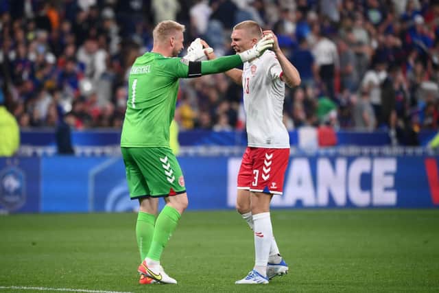 BIG WIN: Leeds United target Rasmus Kristensen, right, celebrates with 'keeper Kasper Schmeichel after Denmark's brilliant 2-1 success against France. 
Photo by FRANCK FIFE/AFP via Getty Images.