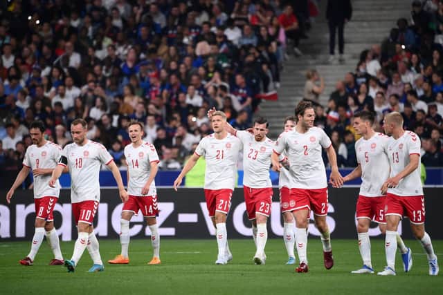 IMPACT: Leeds United target Rasmus Kristensen, right, joins in the celebrations as 
Andreas Cornelius, centre, draws Denmark level en route to a 2-1 victory against France in their own back yard. Photo by FRANCK FIFE/AFP via Getty Images.