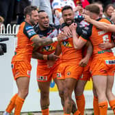 Kenny Edwards, third from left, celebrates his first try which put Tigers 12-0 up against Wigan. Picture by Bruce Rollinson.