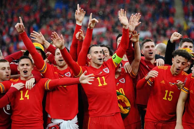 Wales captain Gareth Bales leads his side in celebration of their qualification for Qatar 2022. Pic: Shaun Botterill.