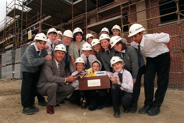 Pupils from Priesthorpe High with a time capsule they planned to bury in the foundations of a new school wing. Pictured with students, from left, are Paul Willis, of Willmott Dixon Construction, Coun Mick Coulson and Judith Hart, head of history at the school.