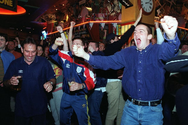 England fans celebrate Alan Shearer's goal against Tunisia at Brannigans in Leeds city centre.