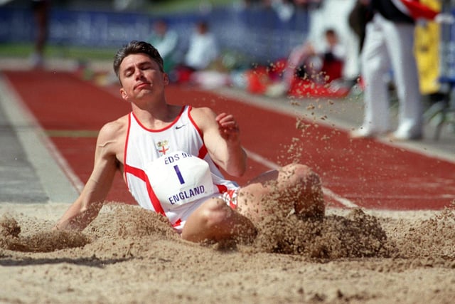 Jonathan Edwards land in the sand after taking part in the triple jump during the Leeds International Athletics meet held at South Leeds Stadium.