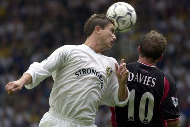 Harry Kewell heads the ball back across goal under pressure from Southampton's Kevin Davies.