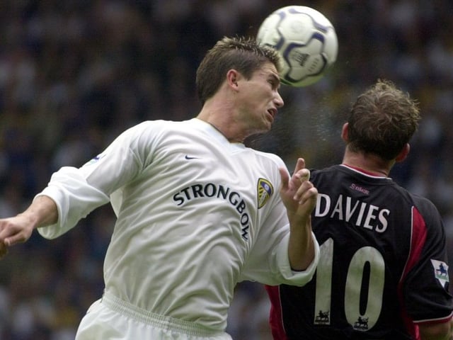 Harry Kewell heads the ball back across goal under pressure from Southampton's Kevin Davies.