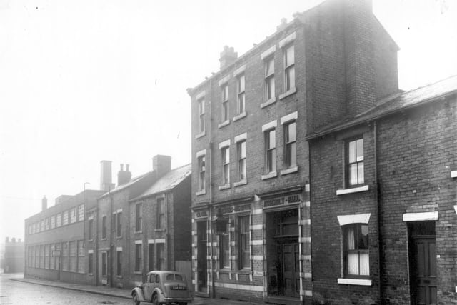 The factory premises of Taylor Bros and Miller Ltd, builders and plumbers merchants on Enfield Road in January 1961. Moving right, then the premises of the Foresters Club and Institute, a Friendly Society.