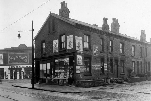 Shops on Roundhay Road between the junctions of back-to-back terraced streets, Badminton Terrace (foreground, right) and Badminton Place (left) in April 1952. The right-hand shop is the business of grocer, Abraham Taylor and number 96, left, was once that of fishmonger, Fanny Jacobs.