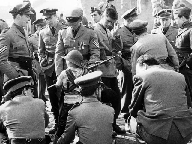 Actors taking a break during the shooting of the filmon a cleared area just off Green Lane. They are playing soldiers in the fictional land of Ambrosia, part of a dream experienced by the title character.