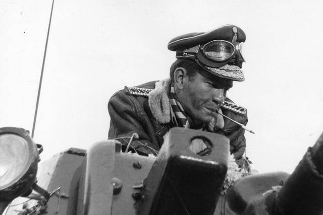 Actor Tom Courtenay during the shooting of the film in which he played the title role. He is seen here in part of a dream sequence in which he drives a tank through the streets of his imaginary land Ambrosia.