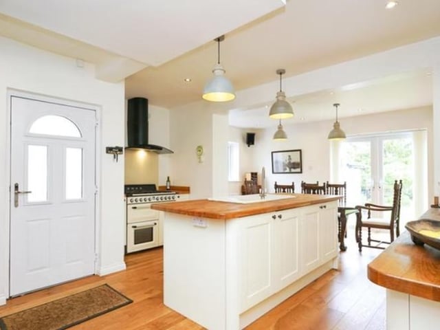 The ground floor has an entrance hall with engineered oak flooring and a large kitchen/diner with patio doors leading into the rear garden.
