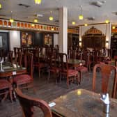 Inside, rows of dark wooden tables stretched out across a surprisingly large dining hall. Photo: Bruce Rollinson