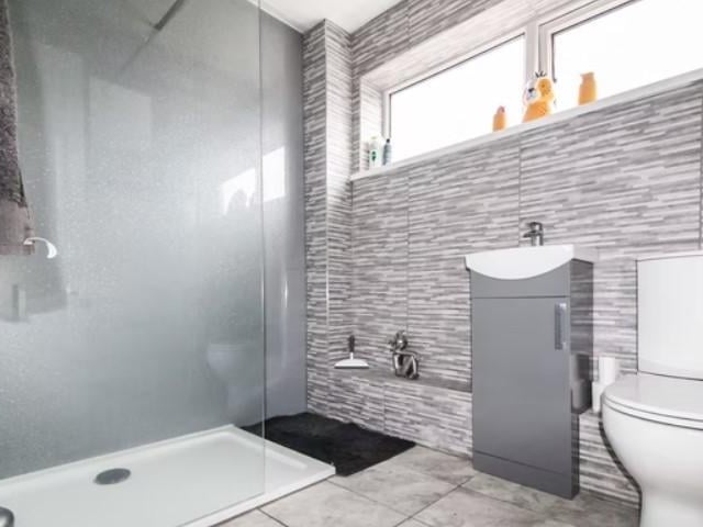 On the first floor is the family bathroom that has a beautiful walk-in shower.