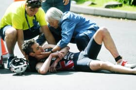 Down and out: Jonny Brownlee is attended to by medics after a nasty crash left him with a broken elbow in his home World Triathlon race. Picture: Jonathan Gawthorpe)
