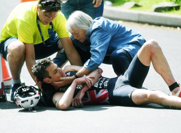 Down and out: Jonny Brownlee is attended to by medics after a nasty crash left him with a broken elbow in his home World Triathlon race. Picture: Jonathan Gawthorpe)