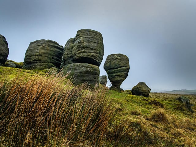 Aptly named ‘Brink-stones’ or edge stones in Old Norse, you can follow footpaths to the top to experience the Bridestones first hand.
These fascinating rocks are the remains of a sandstone ‘cap’ that was originally much higher Jurassic sedimentary rock deposited some 150 million years ago.
The surrounding nature reserve is a high, wild and inspiring blend of open heather, rough pasture, wooded hillsides and stunning summer-flower filled grassy dales. It is a designated Site of Special Scientific Interest.