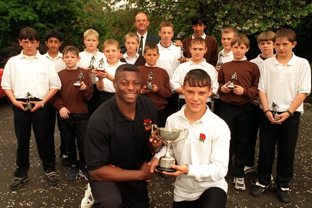 Former pupil turned Bradford Bulls star Sonny Nickle returned to Cockburn tto present the U-13s RL team with their awards and the Dorney-Sheppard Cup. He is pictured presenting the cup to captain Michael Lyons.