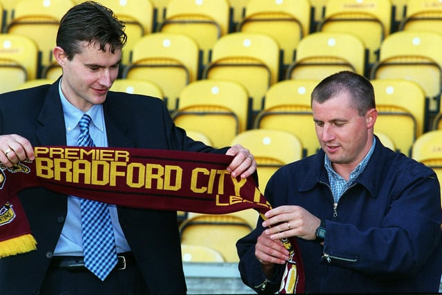 Bradford City manager Paul Jewell (right) unravels a scarf for new signing David Wetherall at Valley Parade.