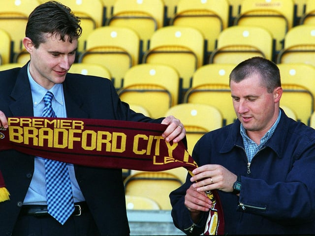 Bradford City manager Paul Jewell (right) unravels a scarf for new signing David Wetherall at Valley Parade.
