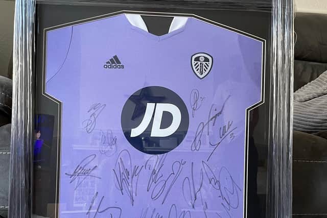 A Leeds United shirt signed by the 2021/22 squad is up for grabs. Credit: Lucy Doherty
