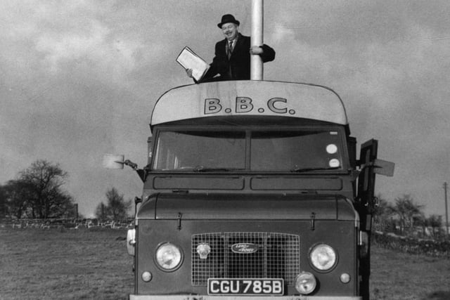Denis Marr, Leeds Corporation's principal assistant planning officer, is pictured with a 70ft. high mobile aerial mast hoisted in a farm field on the heights above Meanwood in January 1969 to show what the Radio Leeds transmitter will look like.