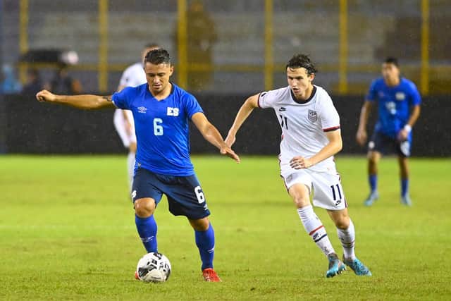 LATEST CAP: Leeds United's USA international Brenden Aaronson, right, challenges El Salvador's Narciso Orellana during the Concacaf Nations League clash in San Salvador in the early hours of Wednesday morning. Photo by MARVIN RECINOS/AFP via Getty Images.