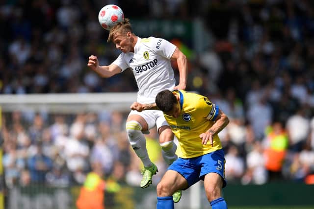 Leeds United forward Joe Gelhardt beats Brighton and Hove Albion's Lewis Dunk to a header. Pic: Oli Scarff.
