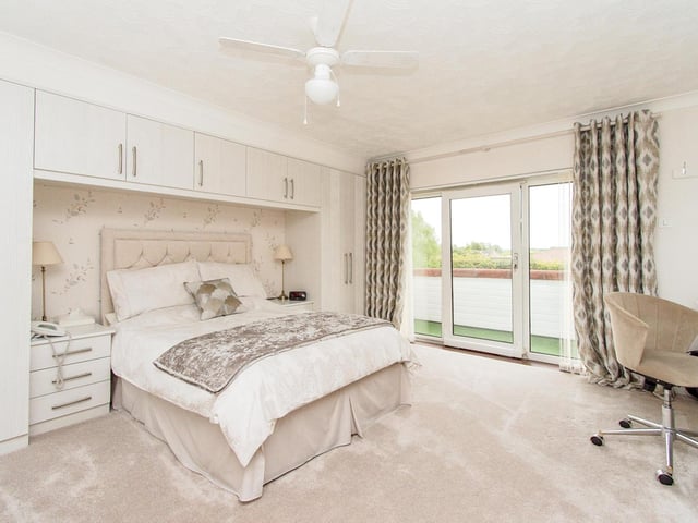 This double bedroom has a window door leading outside.