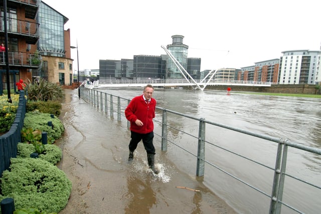 Flooding brought chaos to Leeds city centre in June 2007. Pictured is a resident makes his way to his apartment next to the River Aire.