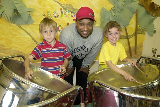 St Benedict's Primary School pupils Liam Durkin (left) and Georgina Pollard with Melvin Bakers from The Workshop Group which co-ordinates the Carribean music development teaching the children about music, dance and visual arts.