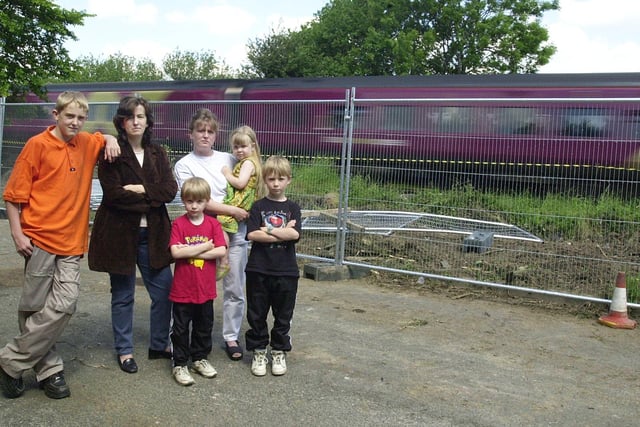 Residents of Elder Garth were unhappy that bushes had been cut down exposing a noisy train line close to their homes. Pictured in June 2000 are Christine Smith with Wendy Addison and her children, Edward, Daisy and William.