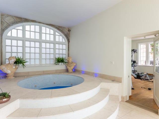 The jacuzzi has a beautiful window behind it allowing in plenty of natural light.