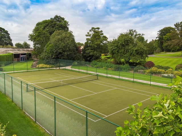 The bulk of the grounds lay to the south and west, the manicured lawns formed into gentle terraces, dissected by gravel pathways passing a parterre and leading down to an all weather tennis court and productive vegetable garden.