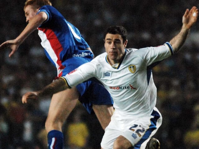 Andrew Hughes battles for the ball with Carlisle United's Chris Lumsden.
