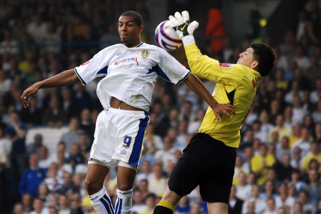 Striker Jermaine Beckford challenges Carlisle United goalkeeper Keiren Westwood.