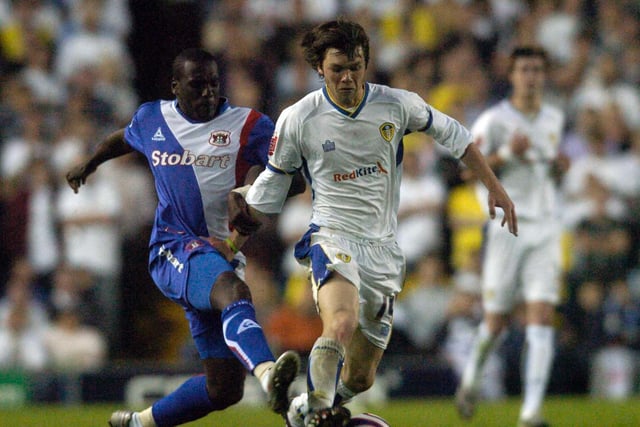 Jonny Howson drives forward under pressure from Carlisle United's Cleveland Taylor.