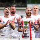 England's Sam Tomkins lifts the trophy after the clash with a Combined All Stars team at the Halliwell Jones Stadium Picture: Martin Rickett/PA