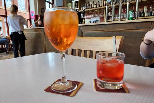 The Aperol Spritz and Reliance Negroni, with a look of a 1970s cop drama duo.