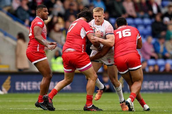 Mikolaj Oledzki is tackled by Combined Nations' David Fifita (number 17) and Chris Satae. Picture by Paul Currie/SWpix.com.
