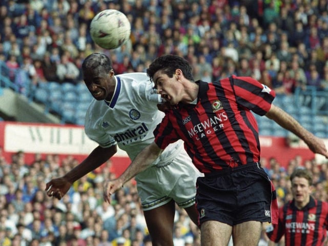 Chris Whyte rises to head clear under pressure from Blackburn Rovers striker Mick Newell.