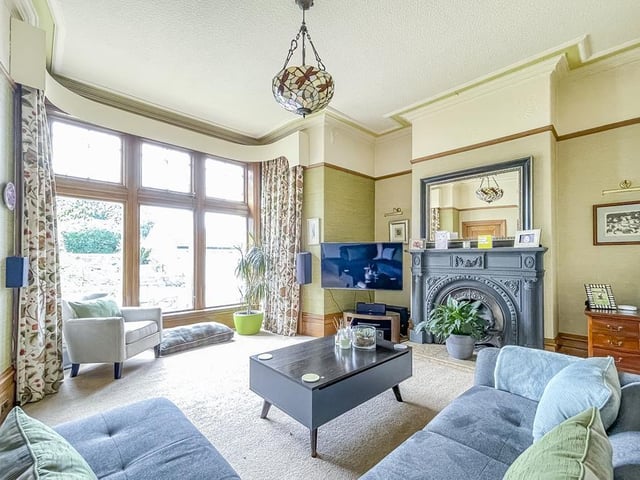 Natural light pours in to this room from the bay window, while the log burning stove within a period marble surround is a focal point.
