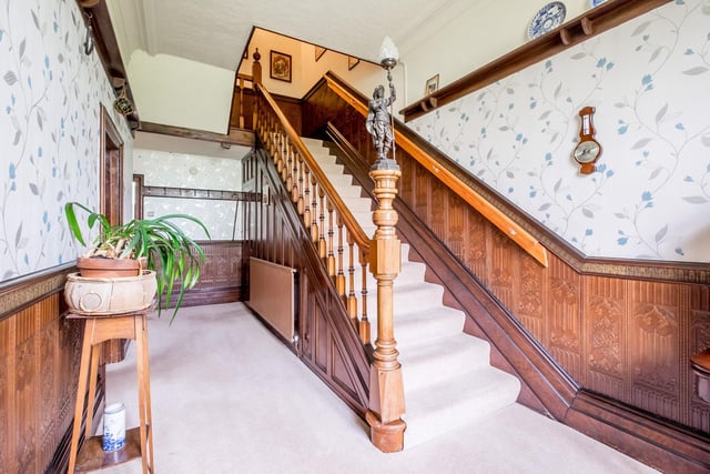 An oak staircase leads up to six bedrooms on the upper floors.