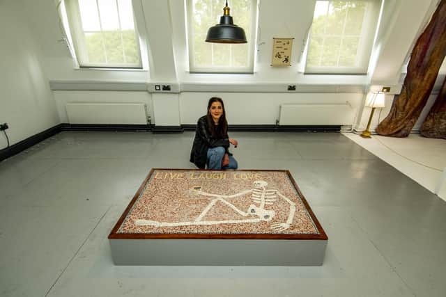 Zoe Ley with her work LIVE, LAUGH, LOVE, 2022 at the School of Fine Art, History of Art and Cultural Studies. Pic: Tony Johnson.