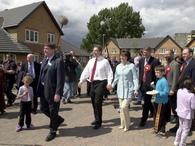 Tony Blair and wife Cherie walk through the new housing development in the Lincoln Green area.
